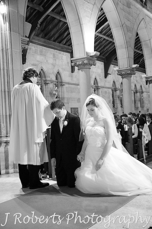 B&W of bride and groom praying - wedding photography sydney